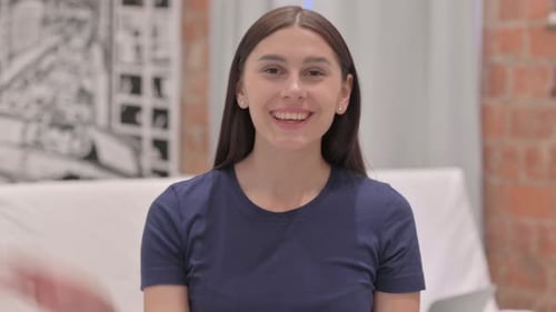 Smiling Brunette Woman Waves to the Camera