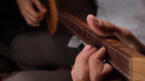 Close-up of Hand Playing Stringed Saz Instrument