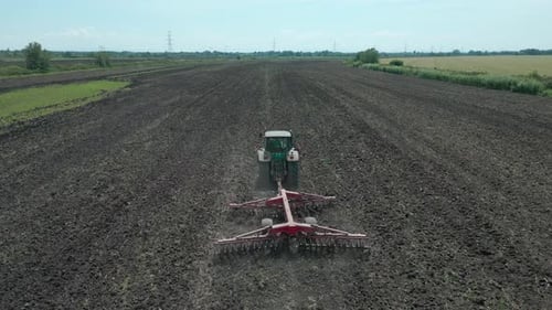 The tractor is plowing the field
