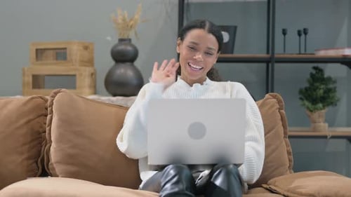 Woman Video Calling on Laptop at Home