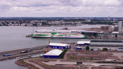 Aerial Footage of Small Motorboat Passing Along Big Cruise Ferry Waiting in Harbour Transportation
