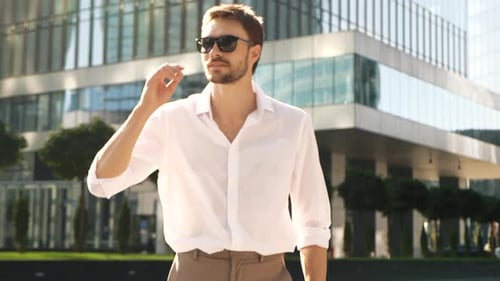 Stylish Man Walks Confidently Toward Camera in City