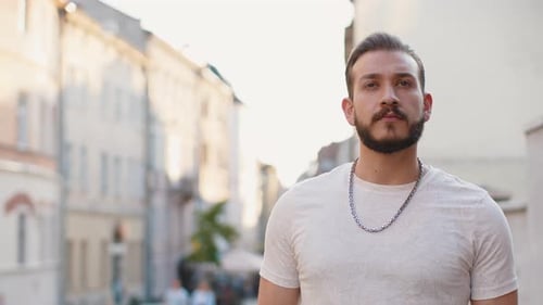 Portrait of Young Man Guy Tourist Walking in Urban City Street Smiling Having Positive Good Mood