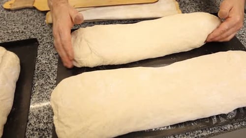 a chef makes bread in a bakery
