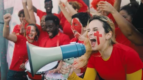 Happy Fans Celebrate at Game With Megaphone