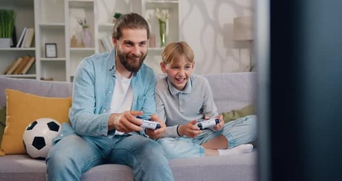 Dad and Son Enjoy Video Games Together