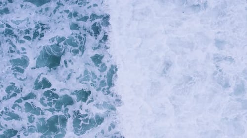 Aerial View of Dynamic Ocean Waves and Foam