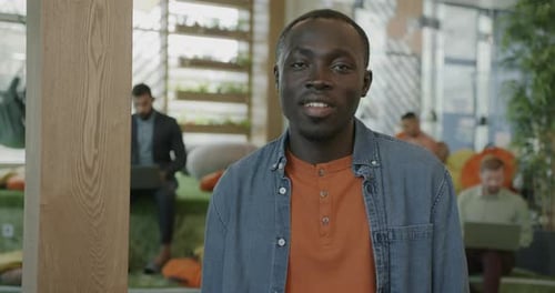 Smiling Man at Work in Modern Office