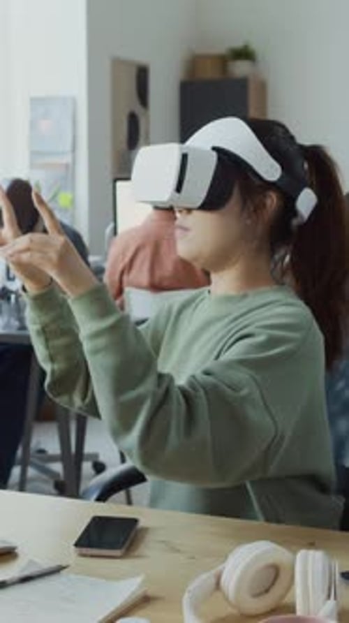 Female Developer Testing New Mobile App in Augmented Reality Headset