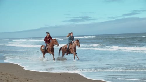 Women riding horses on Oregon beach in super slow motion phantom flex 4k