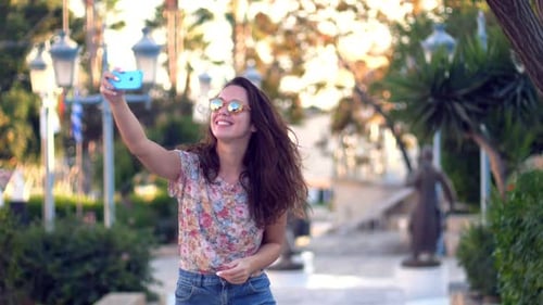 Brunette Girl Posing for Selfie Photo in Tropical City. Cheerful Woman In