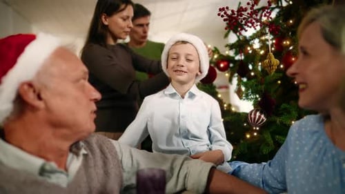 Family Together Near Christmas Tree Celebrates the Holiday