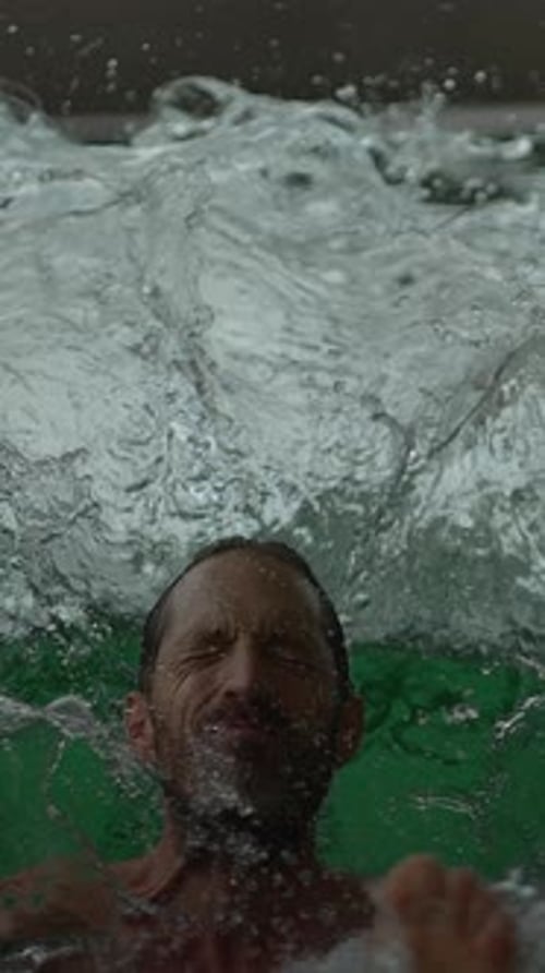 Man submerged in water in a swimming pool