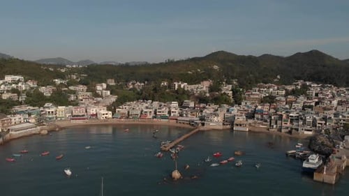 Aerial view of a coastal village located in a beautiful ocean bay.