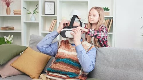 Man Tries VR Headset With Granddaughter's Help