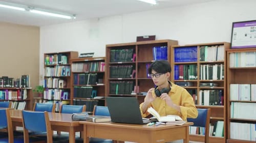 Student, thinking and man in library, laptop and typing with education, university and knowledge.