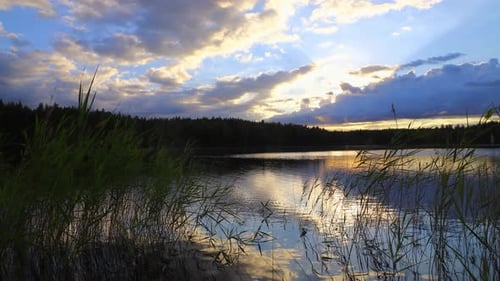 Time lapse of lake scenery with clouds gathering rapidly in sunset.
