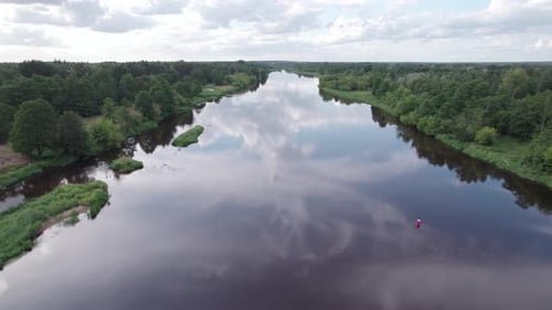 Aerial view of the river in the forest. Mist over the river and beautiful reflection of trees in wat