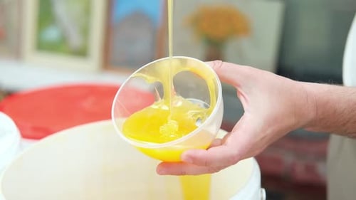 Honey Dripping Dipping Honey with Honey Wooden Spoon in Plastic Jar Healthy Organic Food