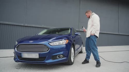 Electric Car is Plugged in to Charge