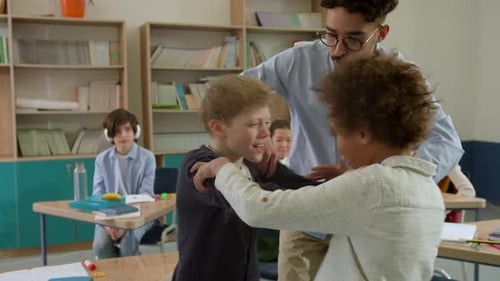 Elementary School Class Children Communicate with the Teacher Answering Question