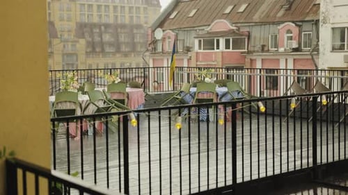 Rain on the Terrace of a Cafe That is Closed Due to Bad Weather