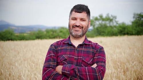 Close Up Portrait of One Happy Arms Crossed Farmer Man Smiling and Looking at Camera with Pride