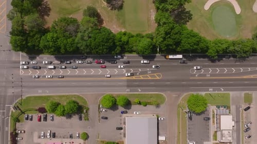 Aerial View of a Busy Intersection in a Small American Town Traffic Vehicles and Buildings a Green
