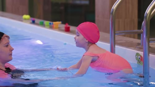 Swim Coach Pulls Little Girl Into Pool Water