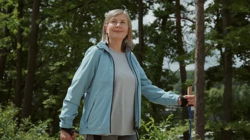 Front View of Attractive Smiling Senior Caucasian Woman Enjoying Time in Nature During a Hike with