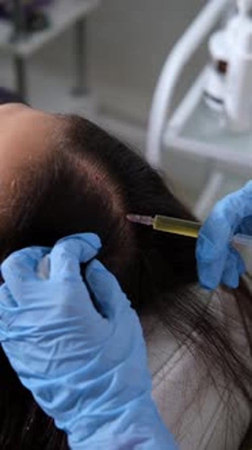 Woman Receives Injection in Scalp at Medical Clinic