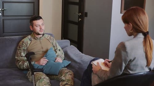 Man in Camouflage Uniform Talks to Therapist