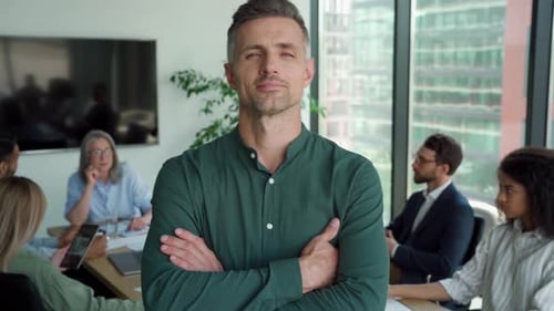 Smiling Confident Mature Businessman Leader Looking at Camera Standing in Office At
