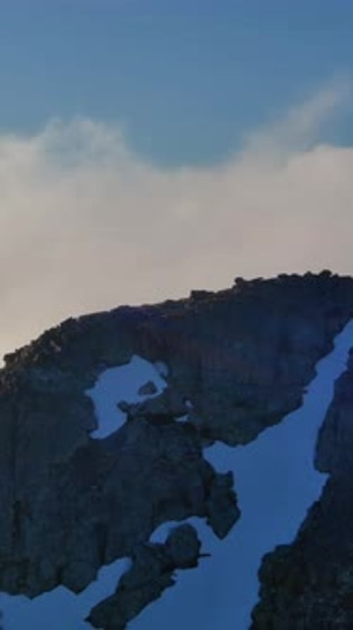Clouds Roll Over Snow-Capped Mountain Peak in British Columbia