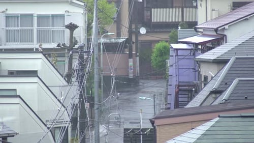 Heavy Rain Drops Falling On The Streets In The Residential Area In Tokyo, Japan.- close up shot