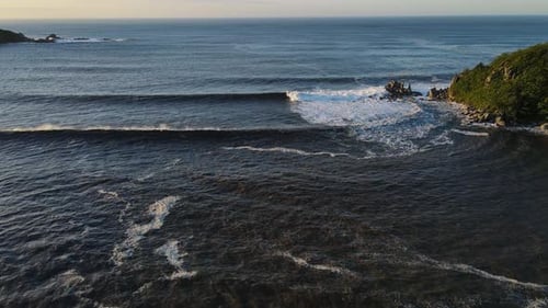 Raging Sea in the Morning at Dawn Waves Roll on the Rocky Shore Spray Soars Into the Sky