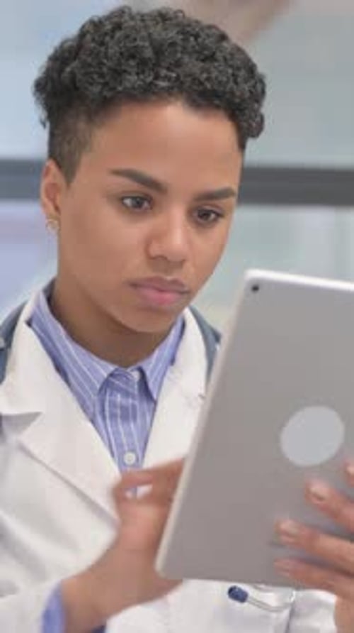 Young Woman Doctor Using Tablet in Hospital Setting