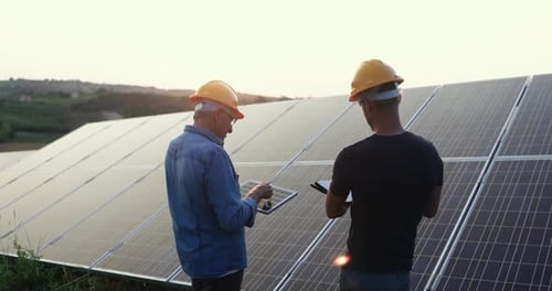 Multigenerational Engineers Working at Solar Panels Factory Outdoor - Photovoltaic, Renewable Green