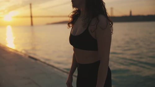 Woman in Athletic Wear Outdoors During Golden Hour