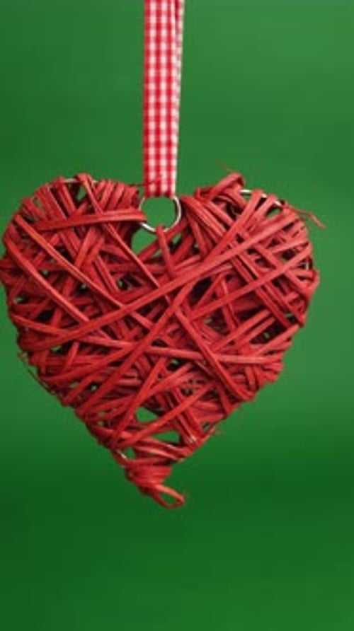 Artisan Crafted Rustic Heart Ornament Hanging Delicately From Checkered Ribbon Amid Greenery