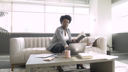 Businesswoman Working at Laptop on Sofa in Office Lobby Adult