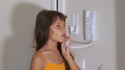 Girl with intercom in flat.