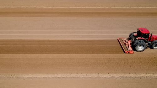 Tractor at Work Preparing the Field for the Upcoming Planting Season