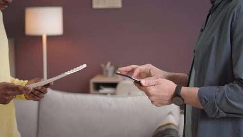 Adults Exchange Documents and Handshake Professionally Indoors