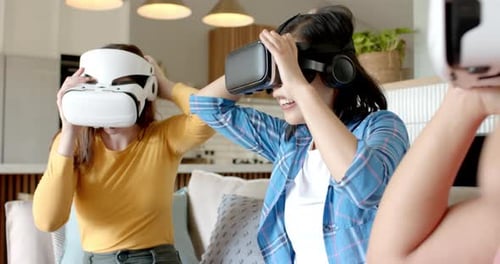 Women Laughing while Wearing VR Headsets