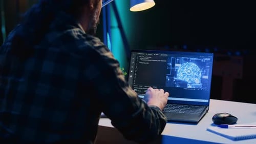 Teleworking IT Specialist in Apartment Office Uses Programming to Upgrade AI