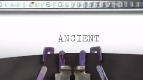 Ancient word closeup being typing and centered on a sheet of paper on old vintage typewriter