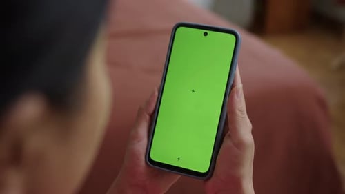 Woman Scrolling Feed on Smartphone with Green Screen
