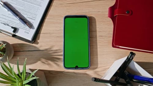 Chroma Key Cellphone Placed on Office Desk Closeup Top View Workspace Organized