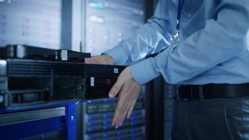 In the Modern Data Center: IT Engineer Installs New HDD Hard Drive and Other Hardware into Server R